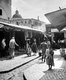 Palestine: The old bazaar at Nazareth with the dome of Mensa Christi Church, c. 1920